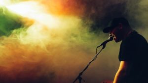 Pro Music Help - Singer performing on stage with microphone